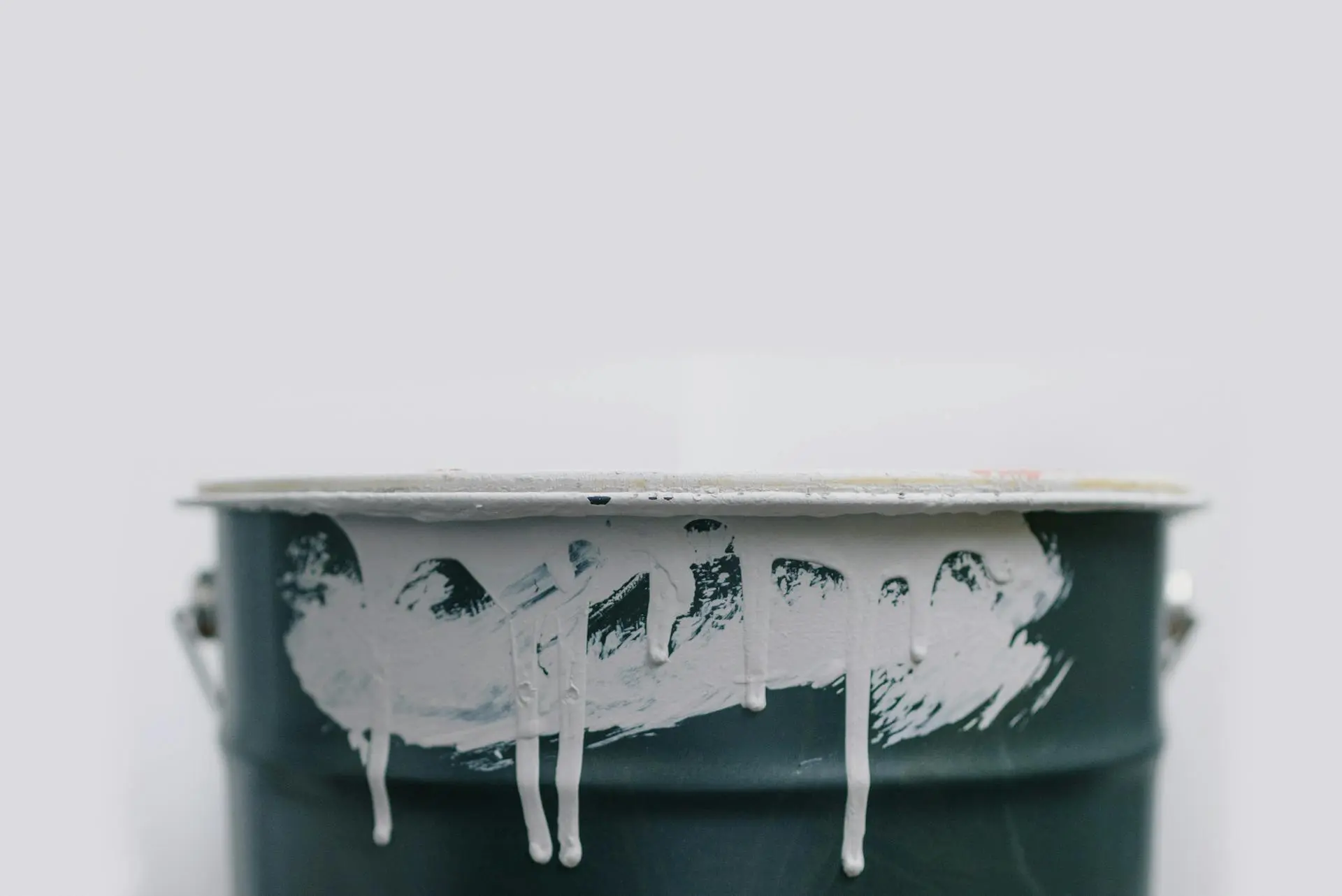 Overflowing metal paint bin