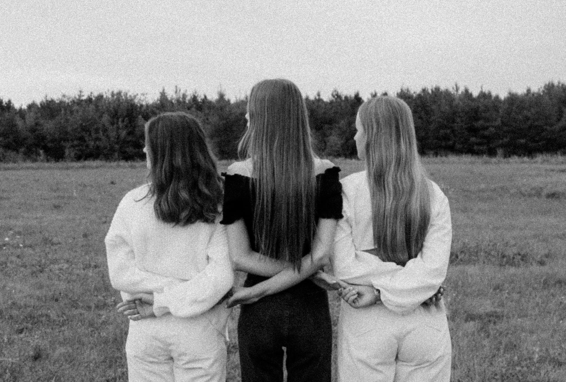 Women linking their arms together