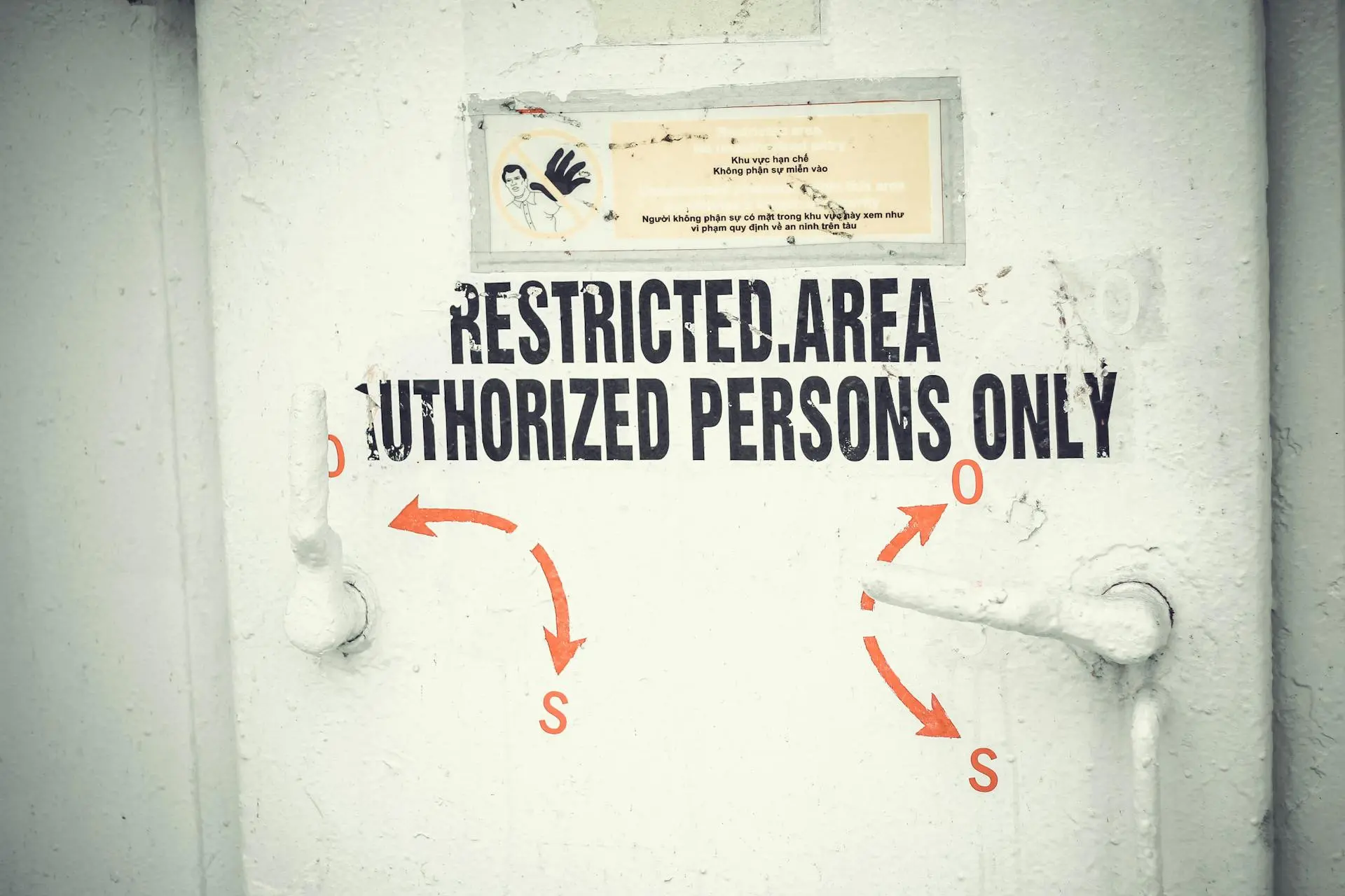 Close-up of a restricted area door with signage emphasizing authorized access only.
