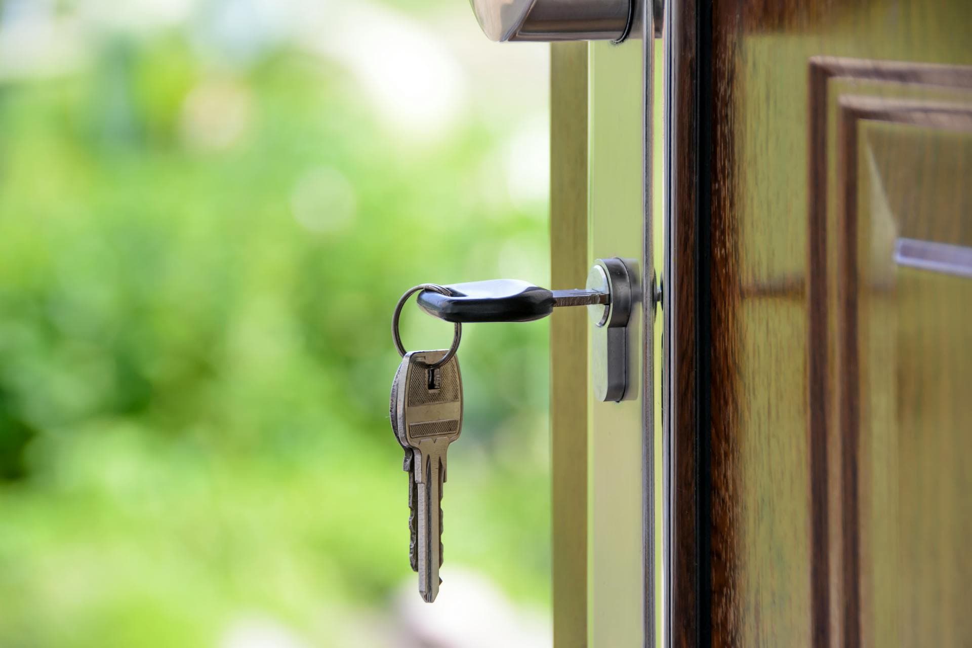 Key in lock, key pair hanging from chain